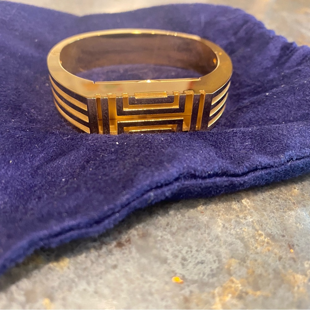 Tory Burch gold Fitbit hinged cuff.